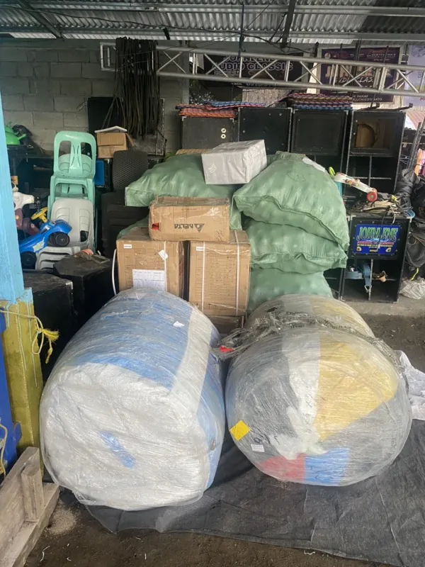 Mixed cargo — sacks, electronics, and wrapped goods — staged at a Jeoffel delivery point in the Philippines