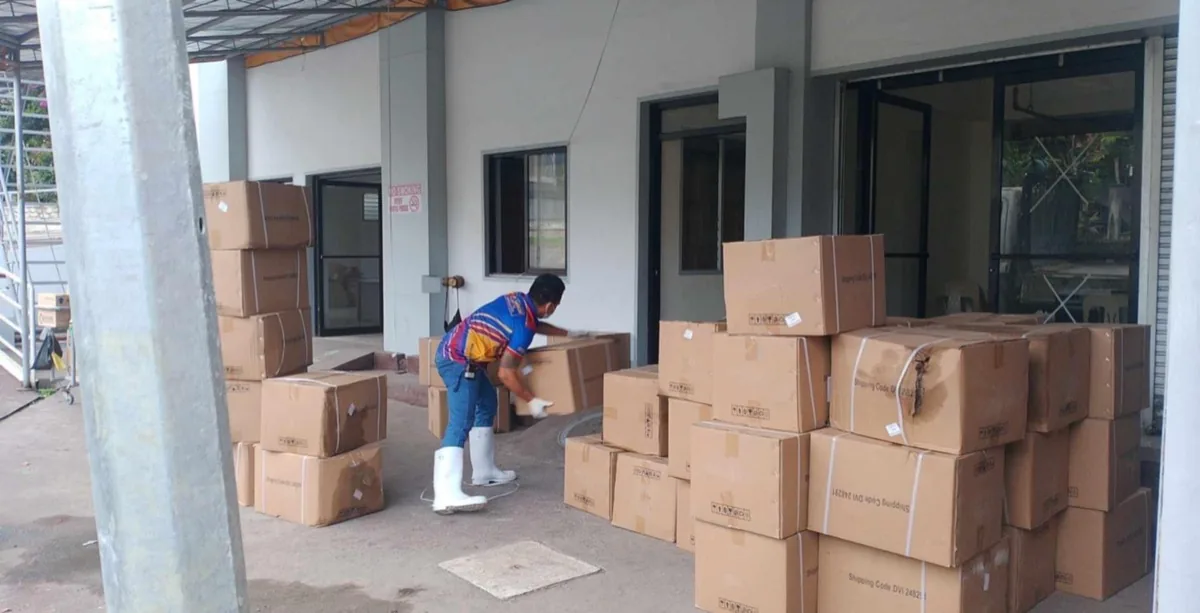 Jeoffel Cargo staff sorting and delivering packages at a client location in the Philippines