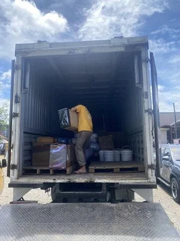 Logistics worker loading freight at warehouse bay
